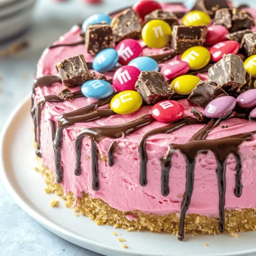No-bake desserts have surged in popularity, and for good reason. They are a perfect solution for those hot summer days when the thought of turning on the oven is less than appealing. These delightful treats are not only simple to prepare, but they also often require minimal cooking skills, making them accessible for both novice and experienced bakers alike. Among the myriad of no-bake options, the Pink Paradise No-Bake M&M Snickers Cheesecake stands out as a vibrant and indulgent choice.